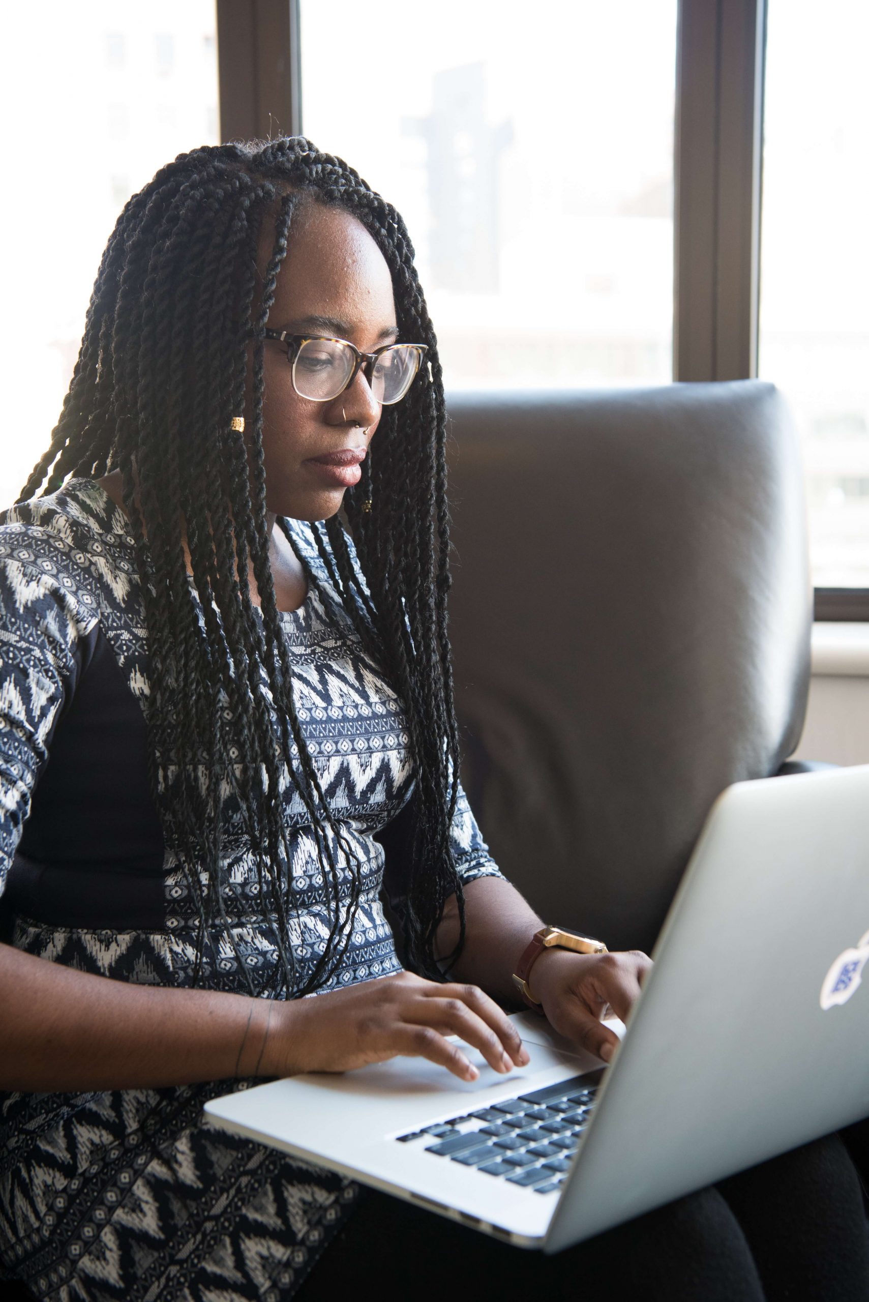 woman-sitting-holding-silver-macbook-1181667